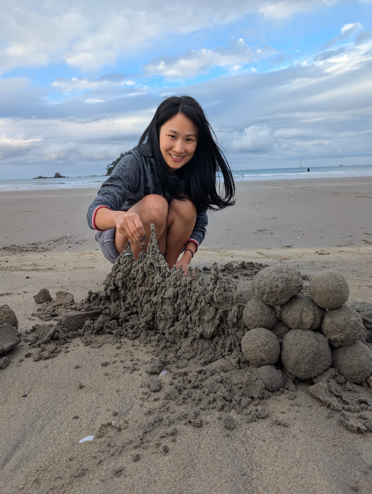 Esther building sandcastles on a New Zealand beach